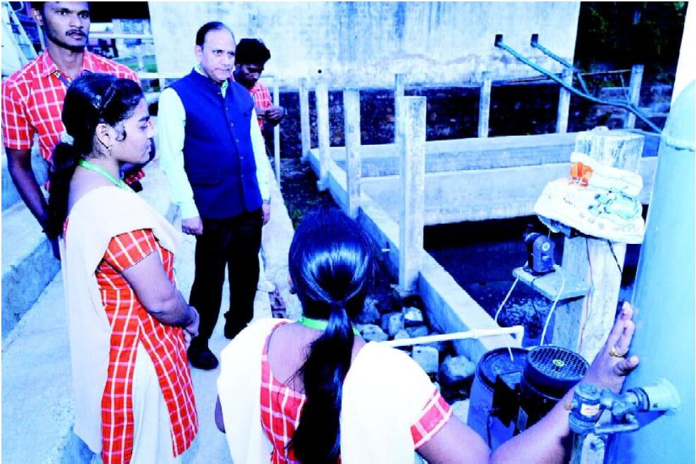 Students observing and recording operations at a campus treatment system
